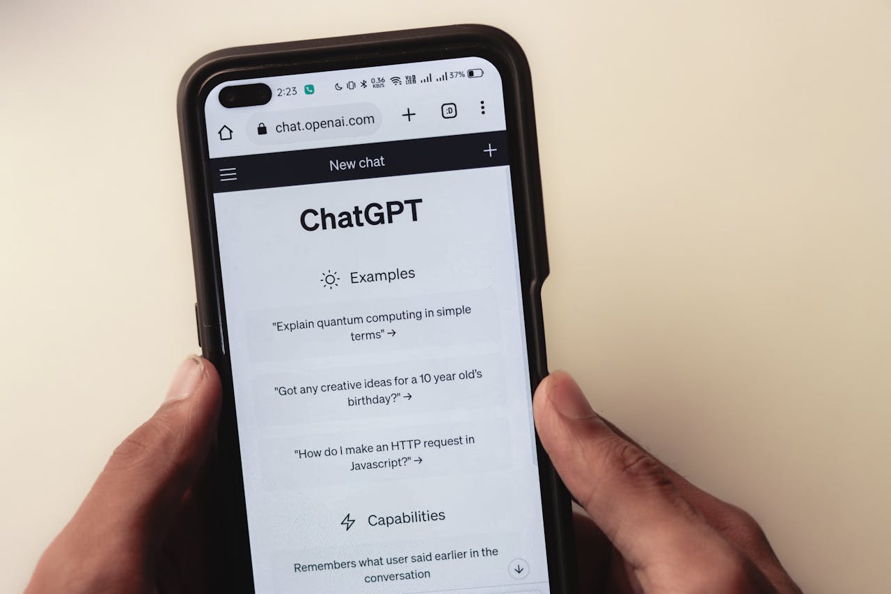 Home Close-up of hands holding a smartphone displaying the ChatGPT application interface on the screen.